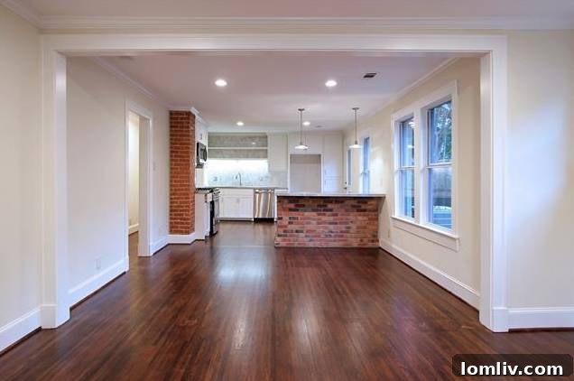 Open view of the dining area leading into the modern kitchen at 1122 Brunner.