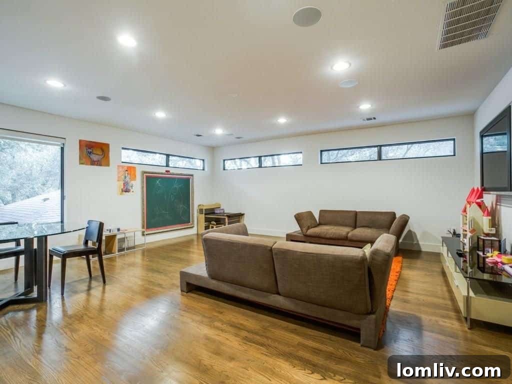 The expansive, light-filled game room on the second floor, offering versatile space for recreation and entertainment, with generous storage solutions.