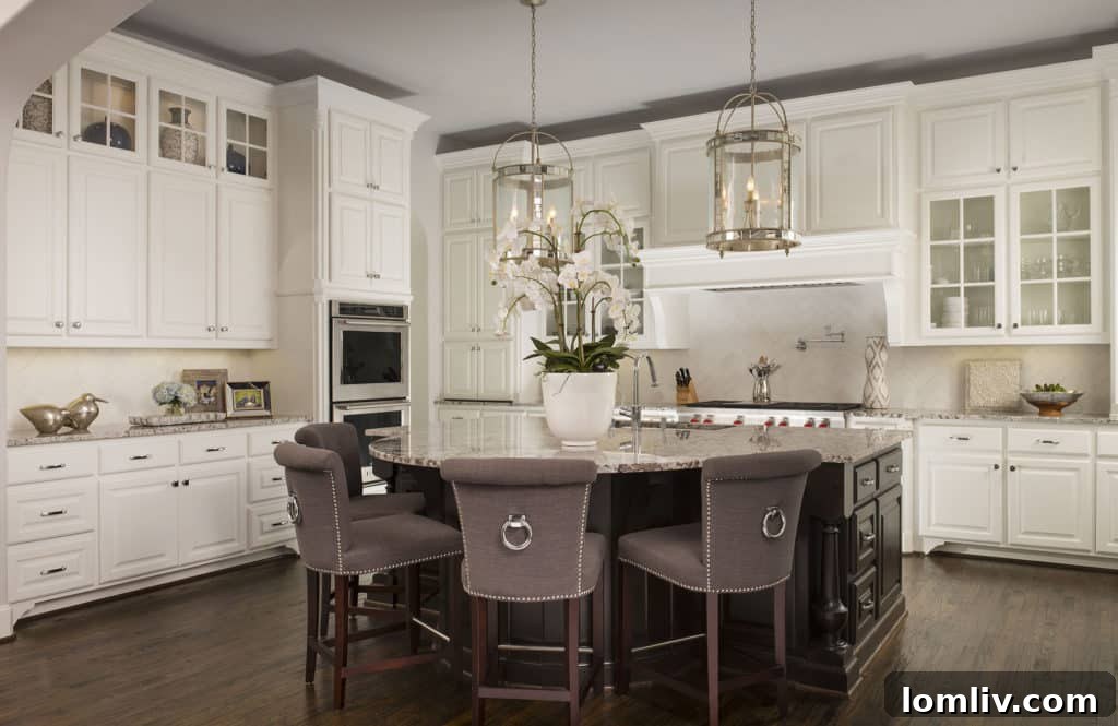 Modern gourmet kitchen with white cabinetry and a curved island