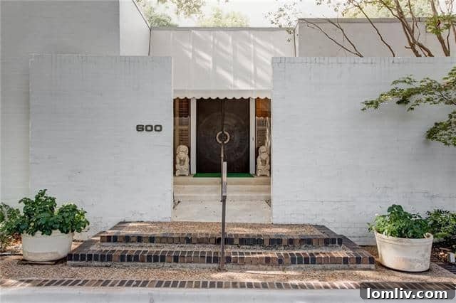 Exterior view of a luxury townhouse in Shady Oaks, Fort Worth, overlooking a golf course.