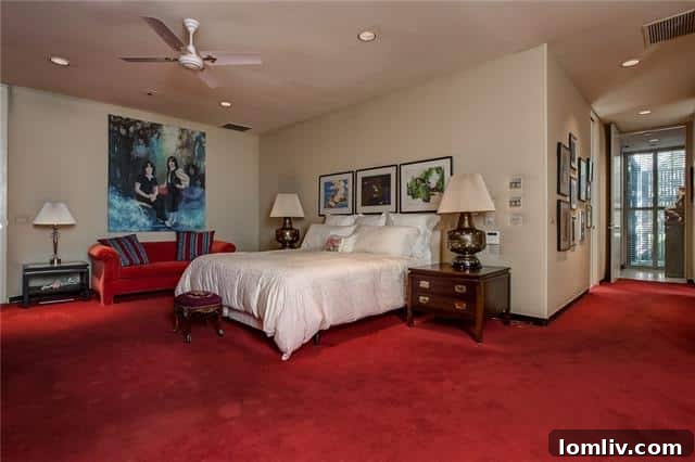 Luxurious master bedroom with pristine red wool carpet, overlooking a private garden.