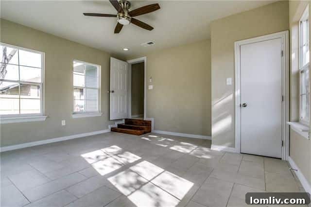 Spacious third bedroom or flex space with abundant natural light