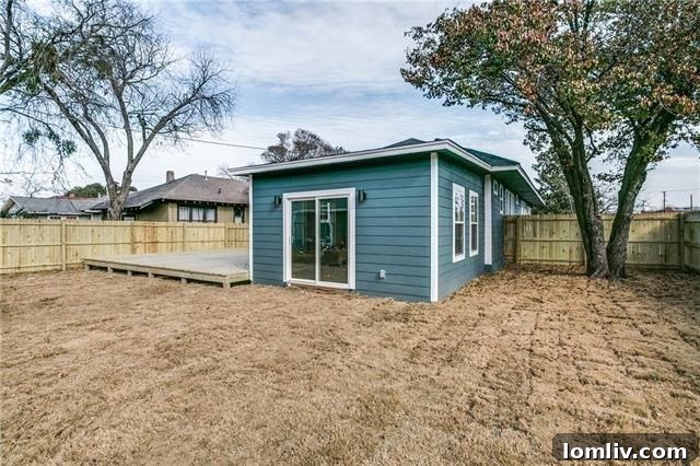 Freshly painted exterior and charming front porch of the North Oak Cliff home
