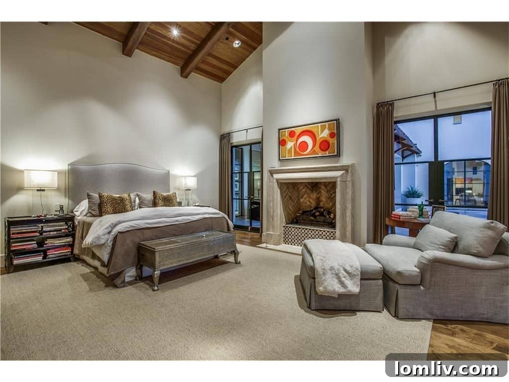 Luxurious master bedroom with a grand timbered ceiling and elegant fireplace