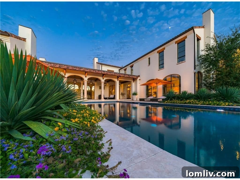 Rear view of the luxurious Preston Hollow home, showcasing its impressive architectural details and extensive grounds