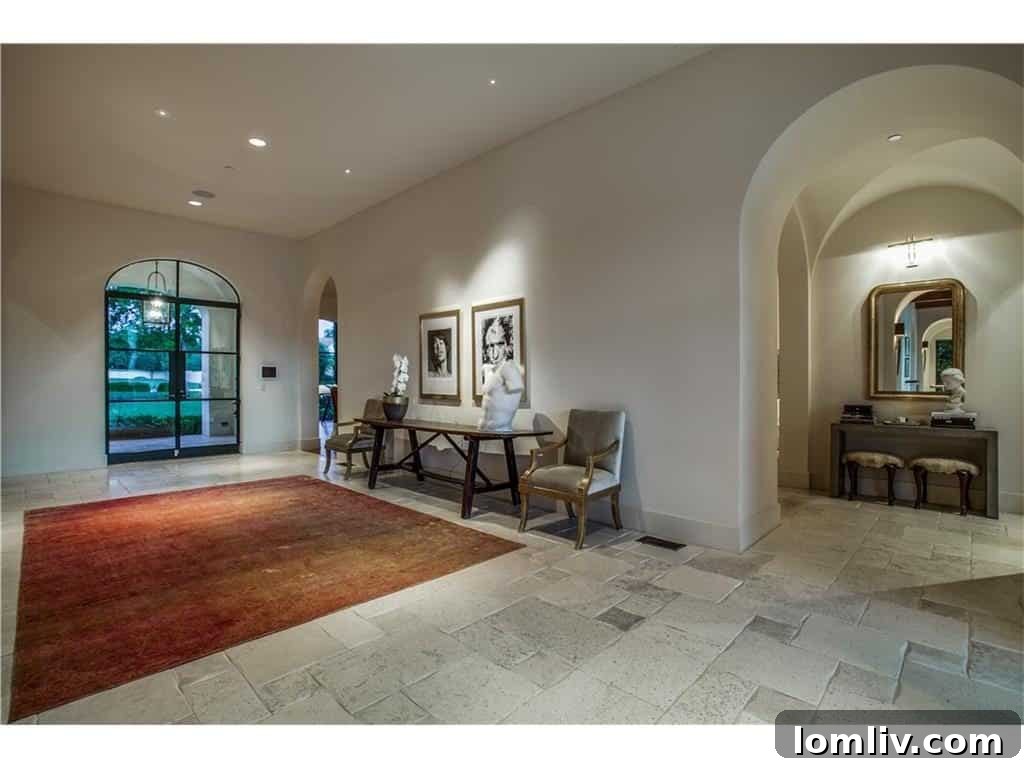 Grand entryway of 10731 Bridge Hollow Court with tumbled travertine floors, diamond plaster walls, and groin-vaulted ceilings