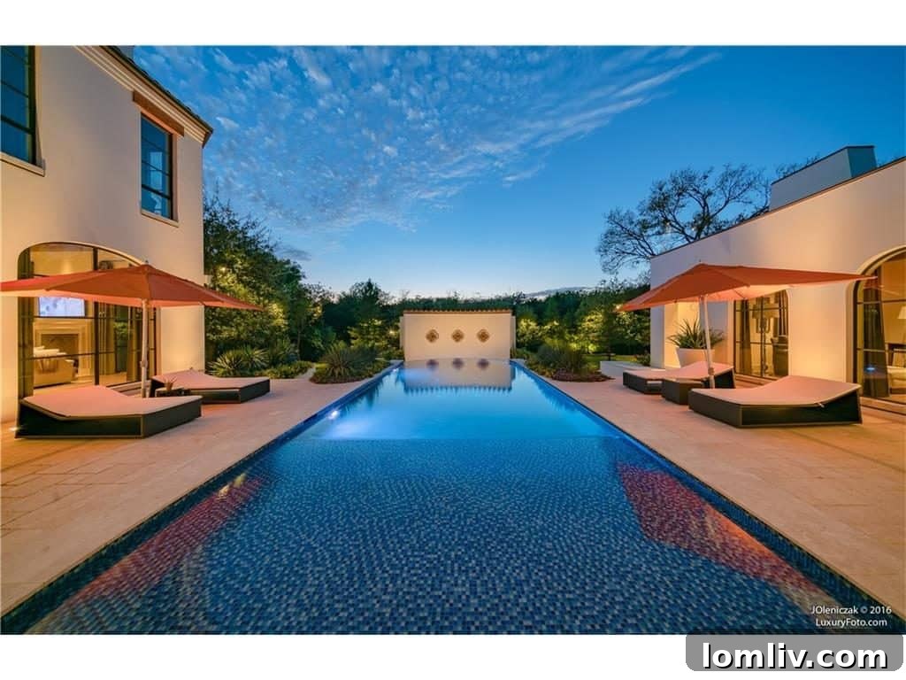 Stunning infinity pool and spa with pristine landscaping at 10731 Bridge Hollow Court