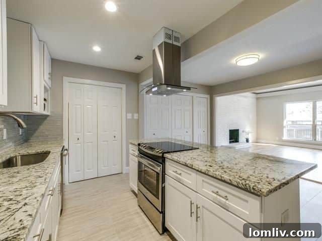 Modern open-concept kitchen with island cooktop and shaker cabinets at 3822 Treeline Drive
