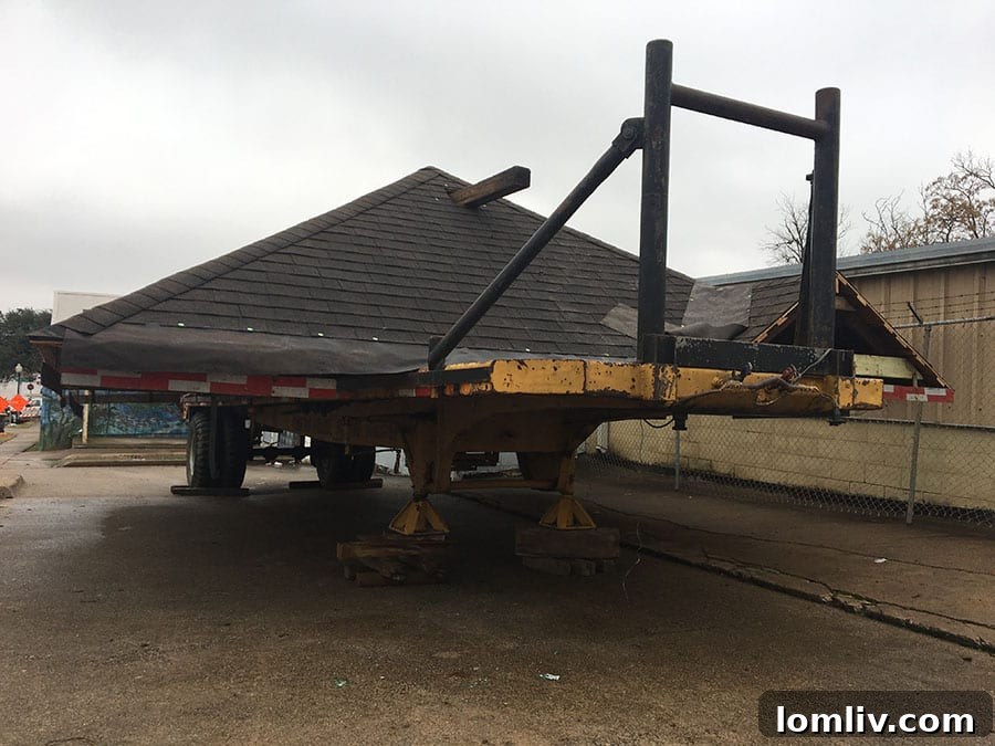 Close-up of the house on transport beams, showcasing the intricate engineering involved in house moving.