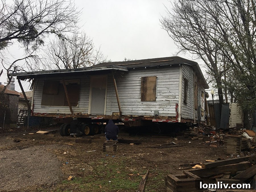 The house partially stripped of its roof and skirting, ready for its journey.