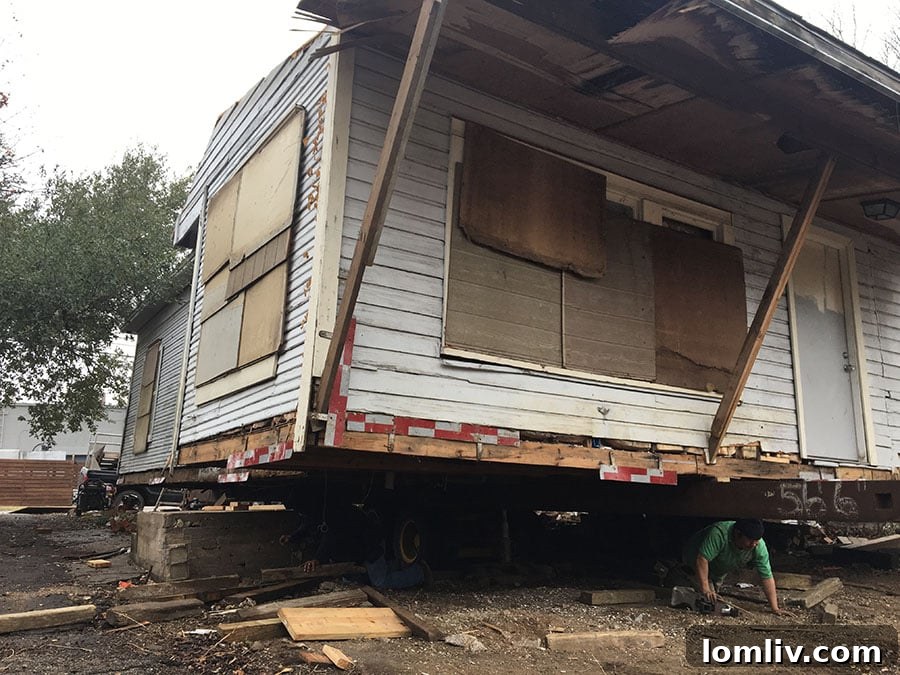 Nighttime scene of the house moving operation, highlighting the scale of the structure.