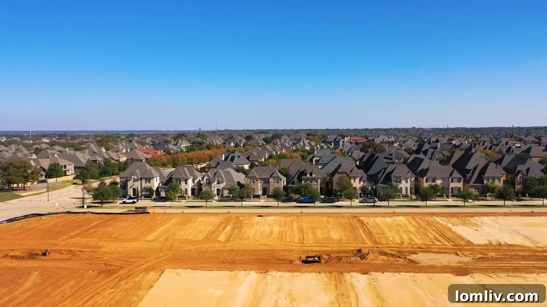 Southlake: Dallas Area's Premier Destination for Neighborhood Excellence 2 Aerial view of Southlake, Texas, showcasing its expansive green spaces and modern infrastructure under a clear sky.