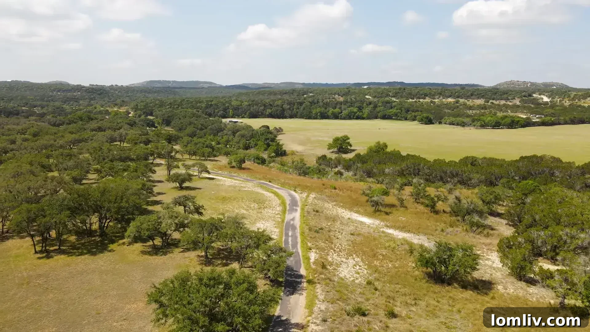 Landscape with a road stretching into the distance, symbolizing land investment opportunities.