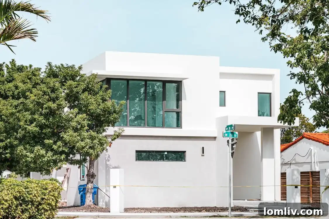 Modern home exterior with neutral paint and strategic lighting