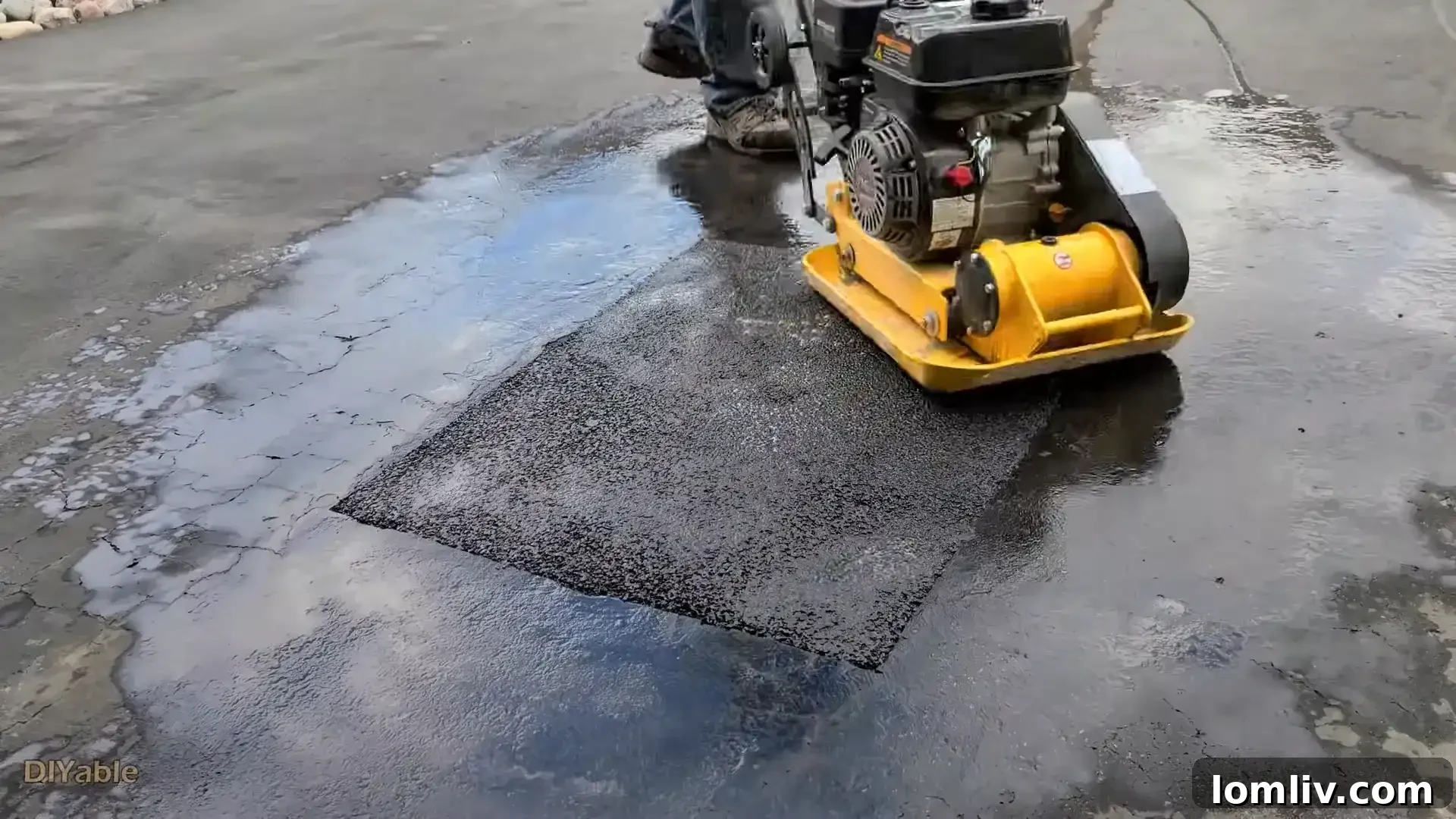 Asphalt driveway showing signs of wear and tear, indicating the need for repair.