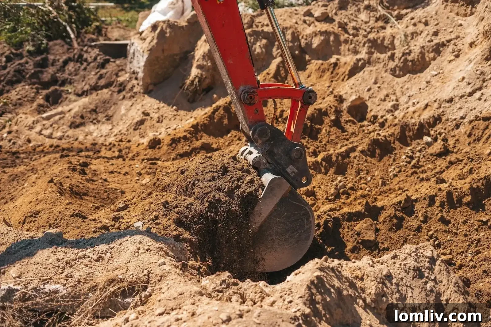 An excavator working on a construction site, emphasizing the initial stages of land preparation.