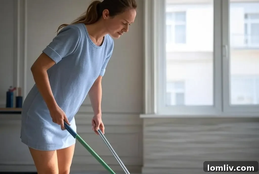 A person cleaning the floor of a new apartment with a mop.
