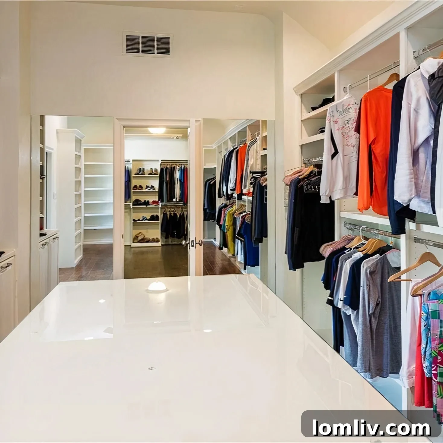 Scottie Scheffler's luxurious, bright white walk-in closet with dark wood floors