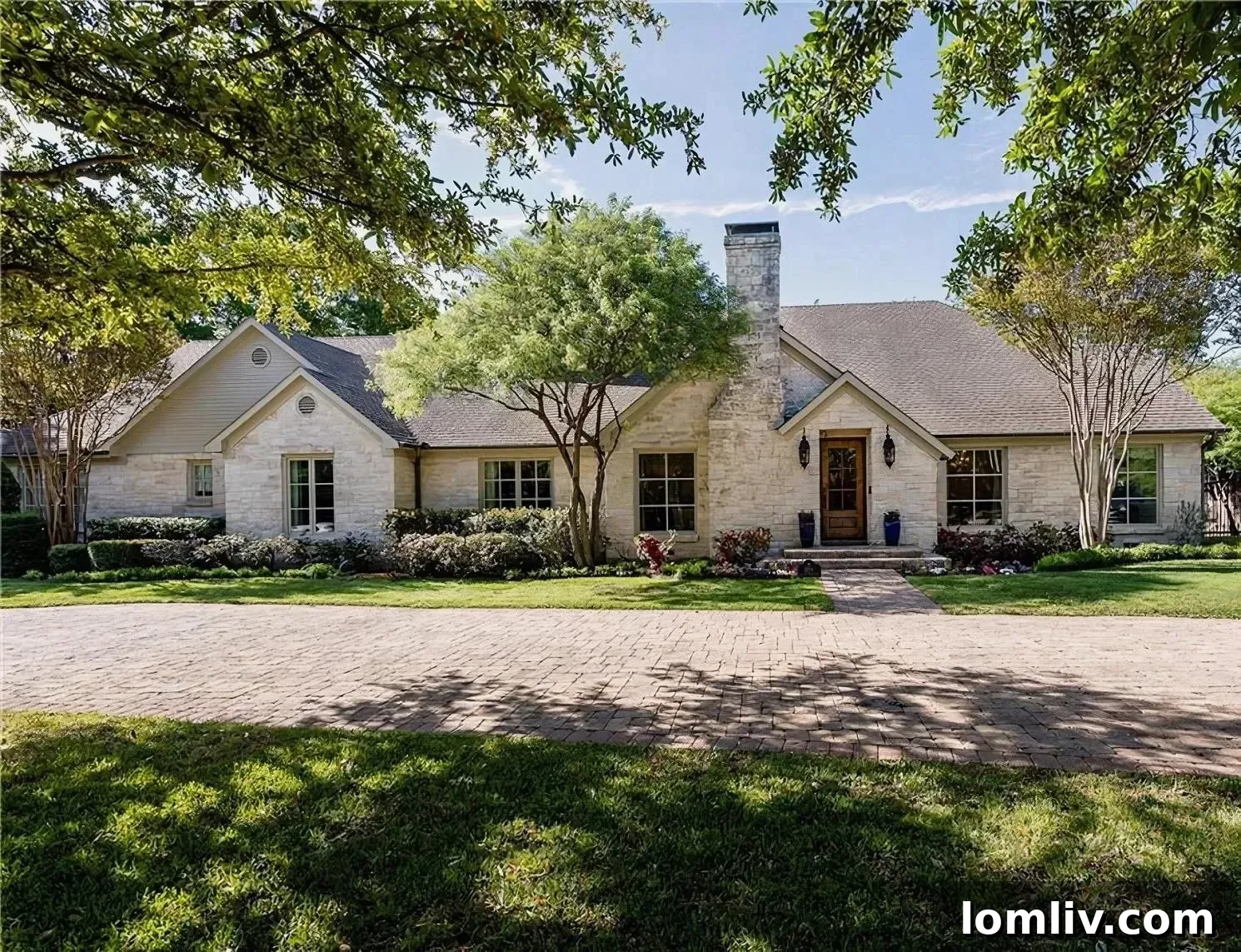 Scottie Scheffler's elegant ranch-style home exterior with light-colored stone and dark roof