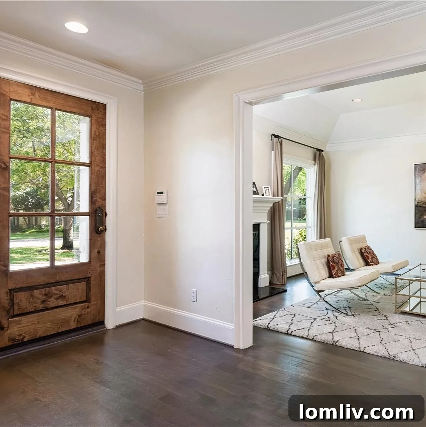 Scottie Scheffler's home main entrance with a natural wood door and creamy walls