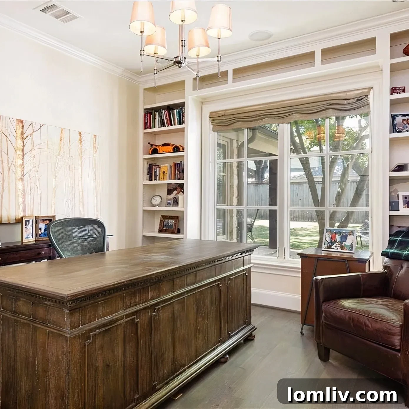 Scottie Scheffler's classic office with a dark brown wooden desk and built-in bookshelves
